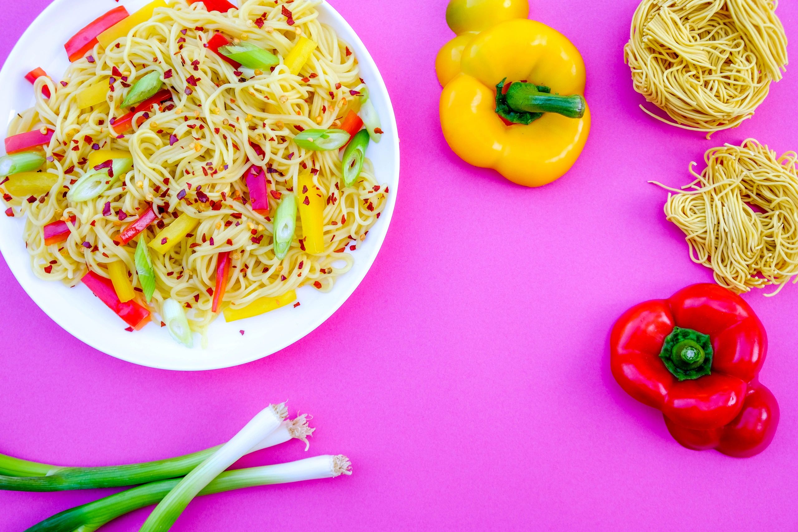 Egg noodle salad with peppers and chili flakes