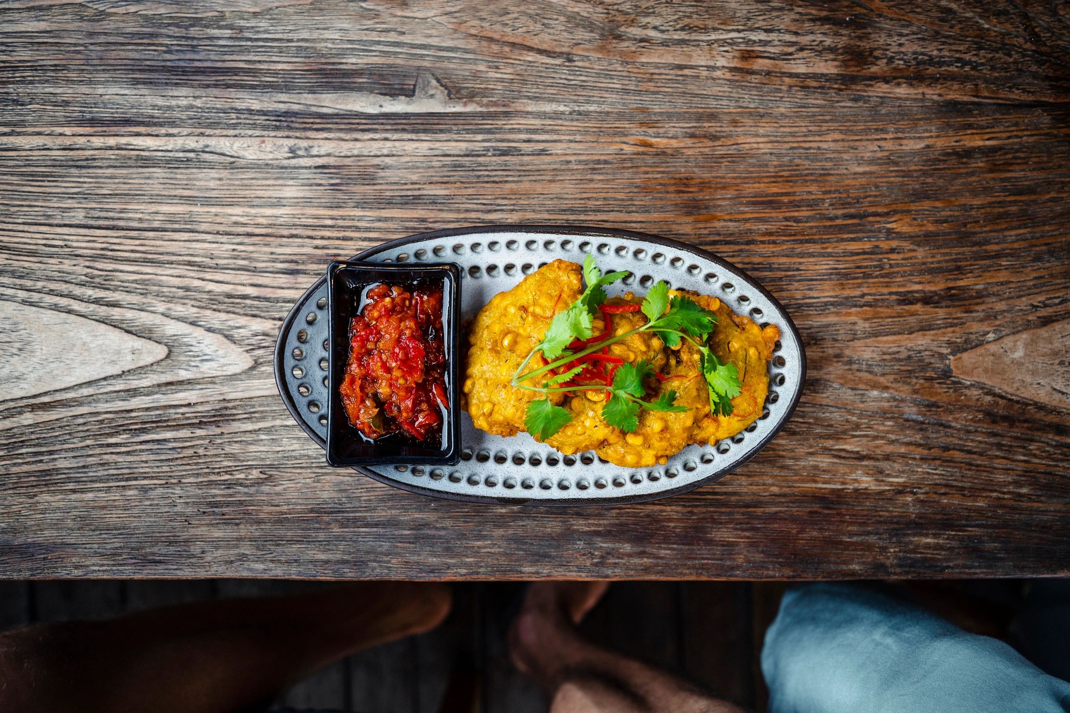 Colorful corn fritters plated for street food service