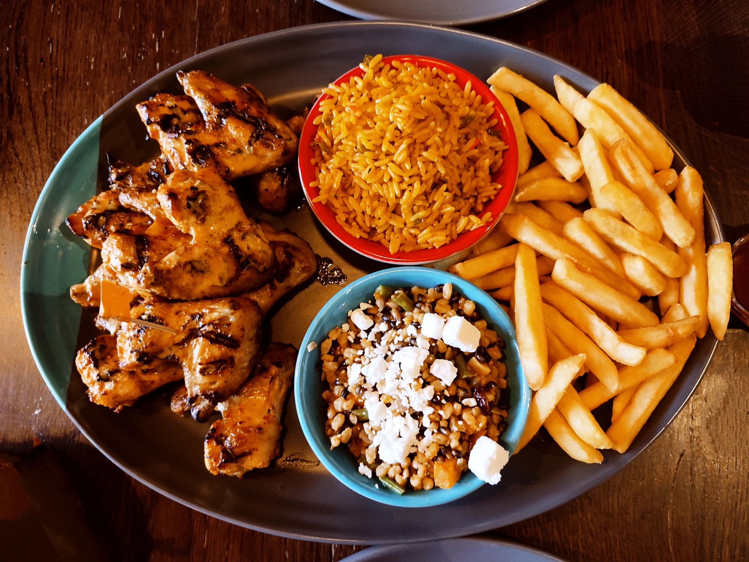 Loaded plate with grilled chicken fries rice and salad